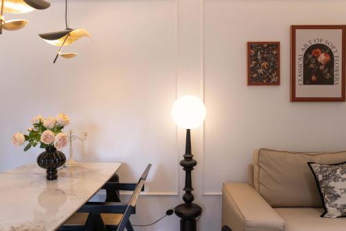 a living room with a table and a lamp and a couch at Shanghai Yi Du B&B - Family Suite 500m to Nanjing West Rd Near People's Square -Credit Cards Accepted in Shanghai