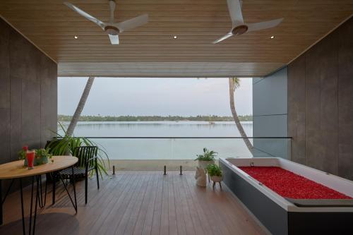 a room with a tub with a view of the ocean at Lago Leisure Resort & Spa in Cherai Beach