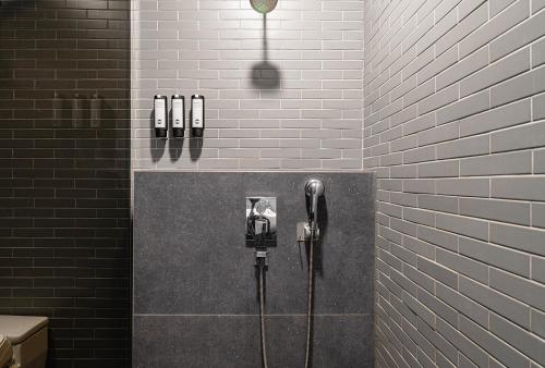 a public bathroom with two parking meters on a wall at Daynice hotel in Boryeong