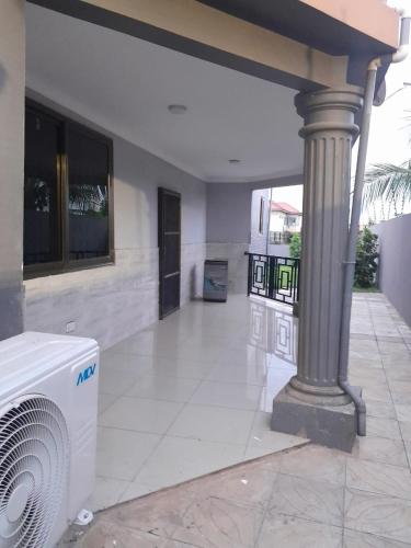 a living room with a fan in a house at Stylish House with Generator - Tema Community 25 in Hanya