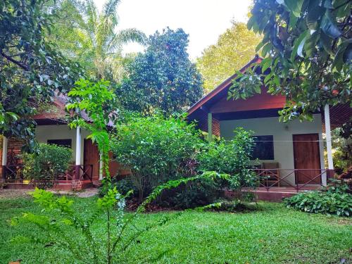 a house with a green yard in front of it at Spirit Mountain in Ban Nong Thale