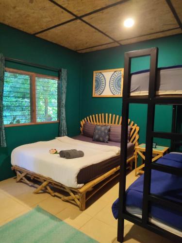 a bedroom with a bunk bed and a ladder at Spirit Mountain in Ban Nong Thale