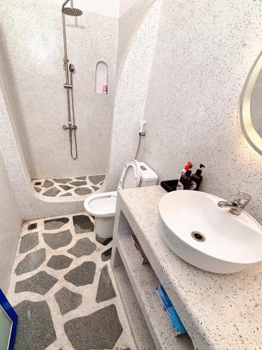 a bathroom with a sink and a toilet at Santorini Villa Cam Ranh in Cam Ranh