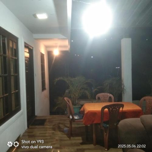 a room with a table and chairs and a light at Ansi Villa in Nanu Oya