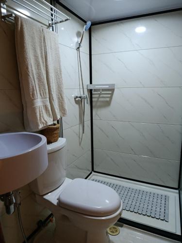a bathroom with a shower and a toilet and a sink at NATUR - Krabi Campsite Glamping & Camping in Krabi