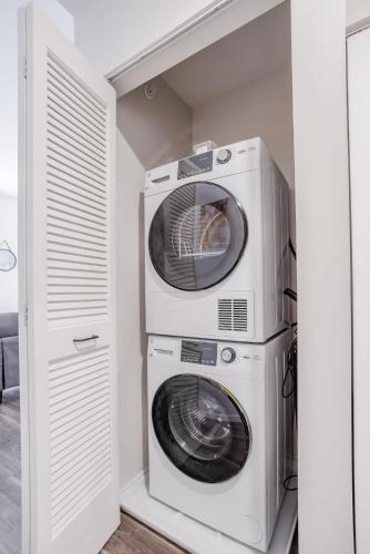 a washer and dryer sitting next to each other at CozySuites Sky Central #9 in Cincinnati