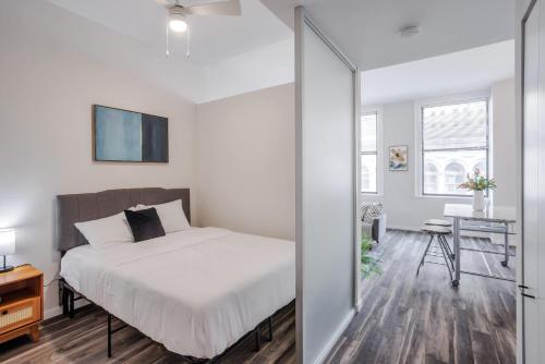 a bedroom with a bed and a table and a desk at CozySuites Sky Central #13 in Cincinnati