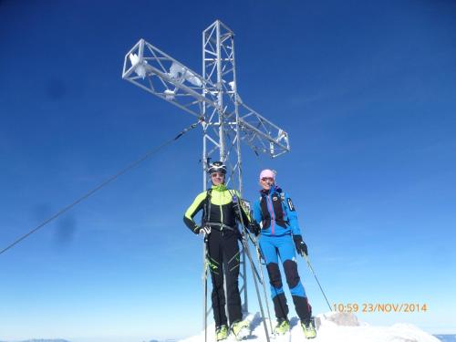two people standing next to a cross on a ski slope at Landhaus Birgbichler - Apartments in Ramsau am Dachstein - inklusive SOMMERCARD! in Ramsau am Dachstein