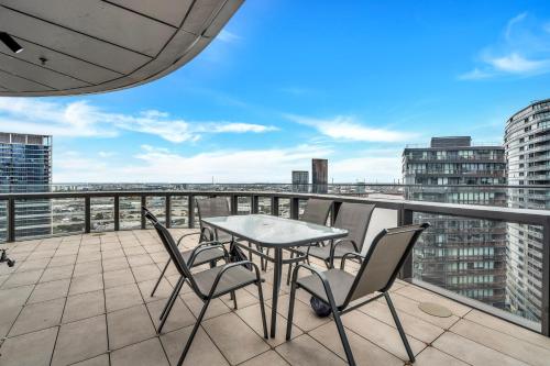 a patio with a table and chairs on a balcony at Melbourne Lifestyle Apartments - Best Views on Collins in Melbourne