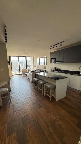 a large kitchen with tables and chairs in a room at SIE7E NEW Condo in Tijuana