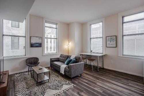a living room with a couch and a table at CozySuites Sky Central #16 in Cincinnati