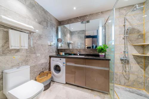 a bathroom with a washing machine and a shower at Weekend International Apartment- Beijing Rd A-mall in Guangzhou