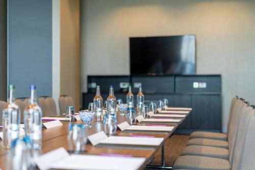 a long table with wine bottles in a room with chairs at Crowne Plaza Aberdeen Airport by IHG in Dyce