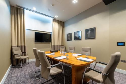 a conference room with a wooden table and chairs at Crowne Plaza Aberdeen Airport by IHG in Dyce