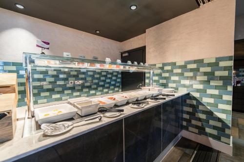 a kitchen with a counter with a row of sinks at Crowne Plaza Aberdeen Airport by IHG in Dyce