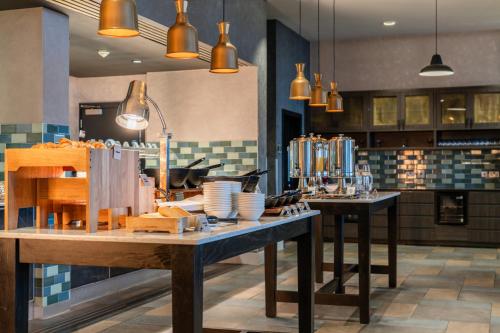 a kitchen with two tables with plates on it at Crowne Plaza Aberdeen Airport by IHG in Dyce