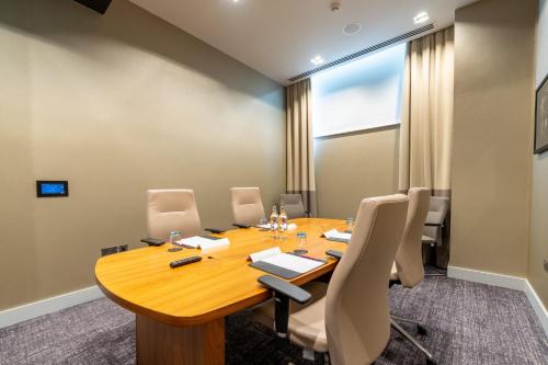 a conference room with a wooden table and chairs at Crowne Plaza Aberdeen Airport by IHG in Dyce