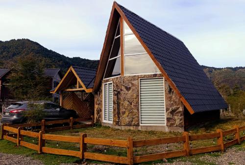a small house with a gambrel roof at Cabañas Nevados Del Valle in Malalcahuello