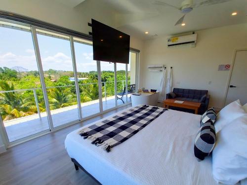 a bedroom with a bed and a large window at Javiellie Luxury Villa in San Ignacio