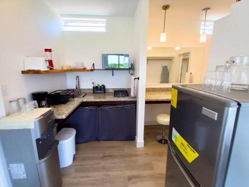 a kitchen with blue cabinets and a counter top at Javiellie Luxury Villa in San Ignacio