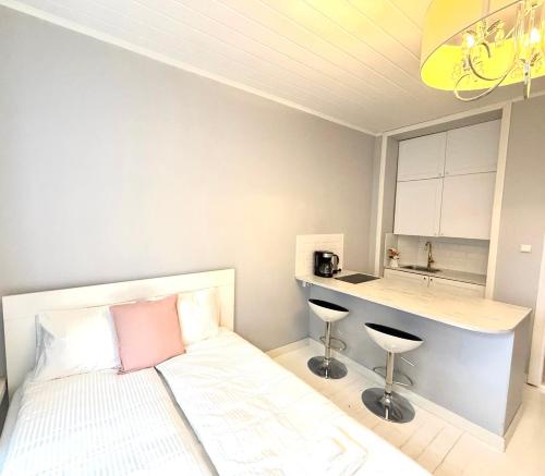 a small bedroom with a bed and a counter at Katas Suite, Helsinki city center in Helsinki