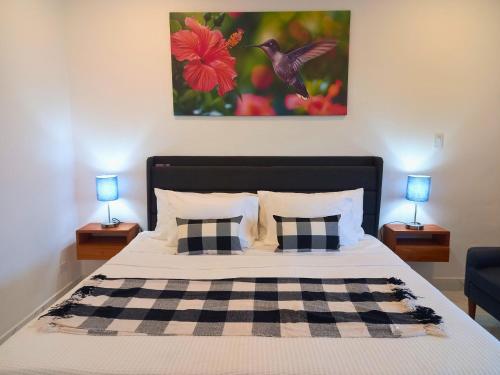 a bedroom with a large bed with two lamps at Javiellie Luxury Villa in San Ignacio