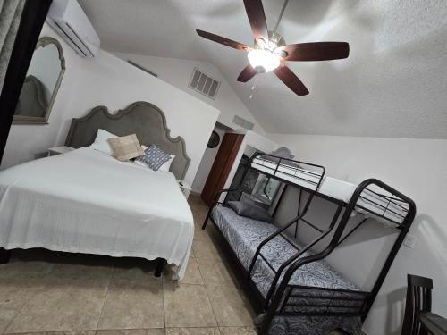 a bedroom with a bed and a ceiling fan at Rocas del sol in Las Vegas