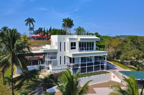 an aerial view of a white house with palm trees at Javiellie Luxury Villa in San Ignacio