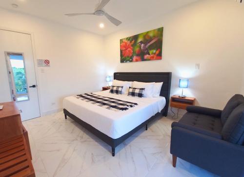 a bedroom with a large bed and a couch at Javiellie Luxury Villa in San Ignacio