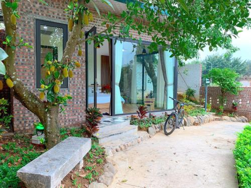 a bike parked outside of a brick house at An Garden Villa - Venuestay in Sơn Tây