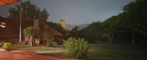 a house with a clock tower in the background at Kruger Park Lodge 243 in Hazyview