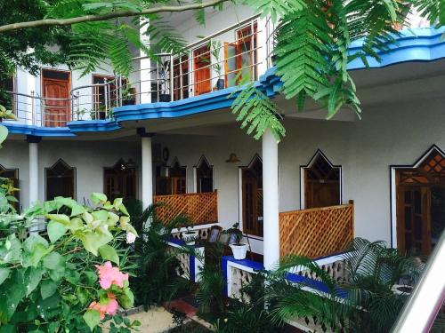 a house with a lot of plants in front of it at A 50 Arugambay in Arugam Bay
