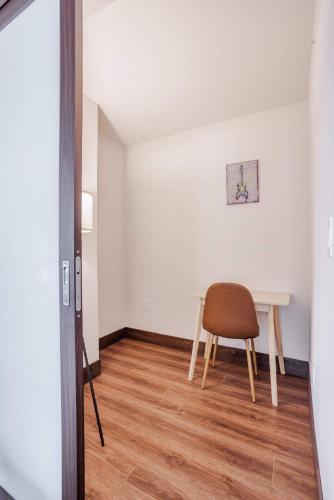 a dining room with a table and a chair at CozySuites Sky Central #21 in Cincinnati