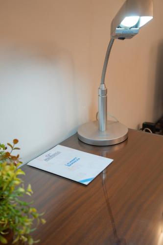 a desk with a lamp on top of a table at Ahuja Residency DLF Phase 2 in Gurgaon