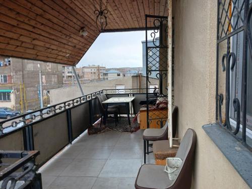 a balcony with chairs and a table on a building at Norik's Guest House in Sevan