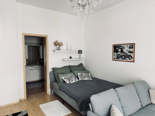 a living room with a couch and a bed at DG City-Apartment in Spremberg