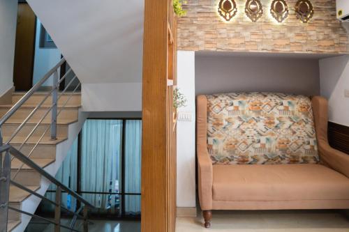 a stairway with a chair in a room at Ahuja Residency DLF Phase 2 in Gurgaon