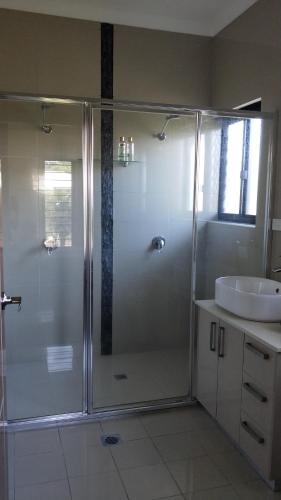 a bathroom with a shower and a sink at Beautiful Modern House near Darwin in McMinns Lagoon