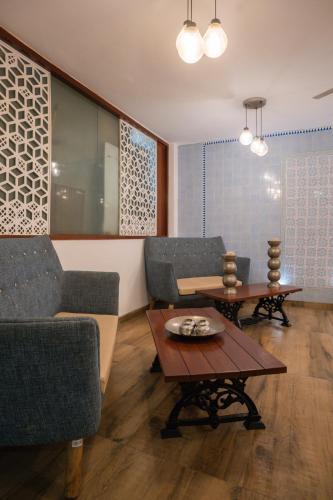 a living room with two chairs and a table at Ahuja Residency DLF Phase 2 in Gurgaon