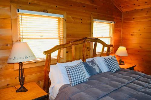 a bedroom with a bed in a log cabin at Above Expectations-New Exterior-Sleeps 8-Hot Tub-Games Galore-Nature in Morganton