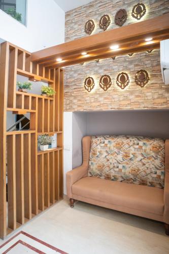 a living room with a couch against a brick wall at Ahuja Residency DLF Phase 2 in Gurgaon