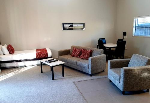 a living room with two chairs and a couch at 37 The Landing Motel in Whakatane