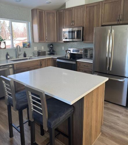 a kitchen with a white counter top and a refrigerator at City Retreat, 2bdrm near Airport in Anchorage