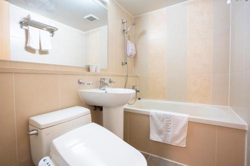 a bathroom with a toilet and a sink and a bath tub at Toyoko Inn Daejeon Government Complex in Daejeon