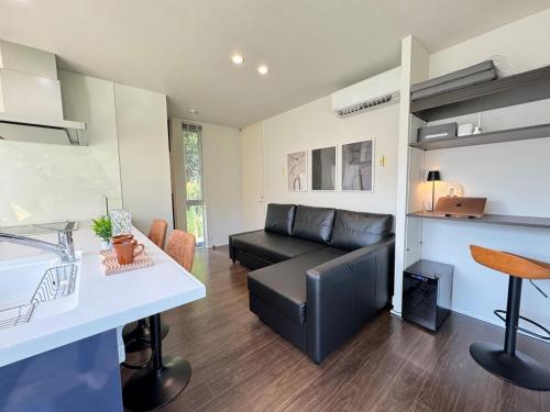 a living room with a couch and a table at グランピング宿 星空テラス&暖炉の庭付き戸建 Orion in Miyamae