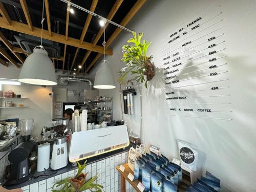 a kitchen with a counter with a wall with glasses at グランピング宿 星空テラス&暖炉の庭付き戸建 Orion in Miyamae