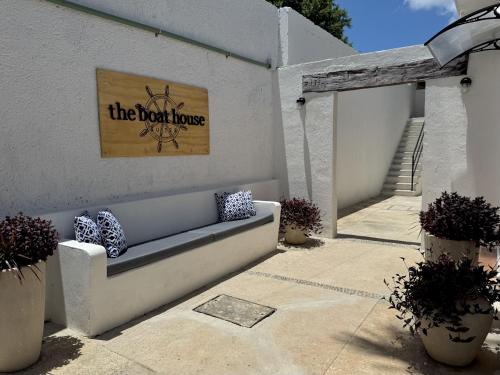 a patio with a bench and a sign that reads the north house at The Boat House Suites in Cancún
