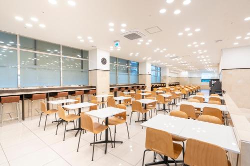 an empty lecture hall with tables and chairs at Toyoko Inn Daejeon Government Complex in Daejeon