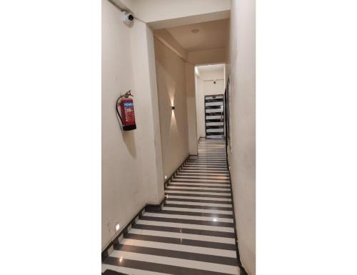 a stairway with black and white stripes in a building at Hotel Shree Maya, Omkareshwar in Godarpura