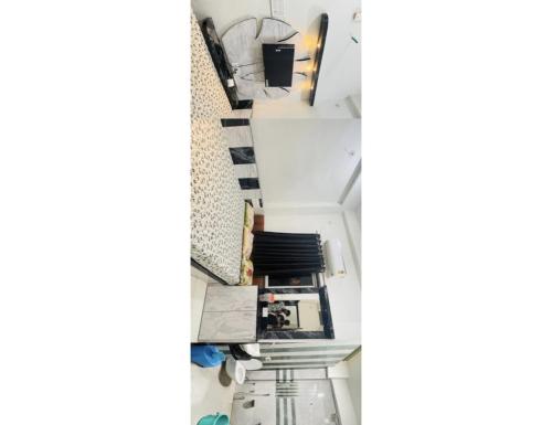 a hallway with stairs and shelves with items on it at Hotel Shree Maya, Omkareshwar in Godarpura